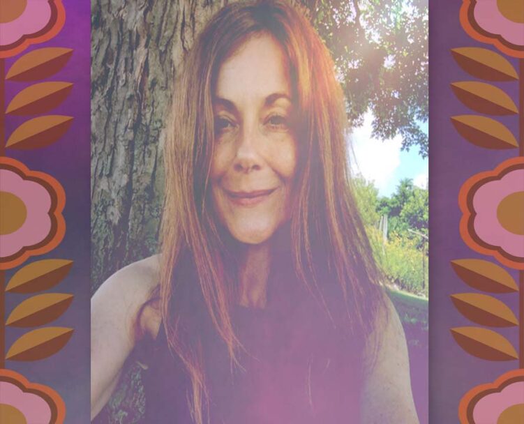 Jess outdoors sitting beneath her favorite tree